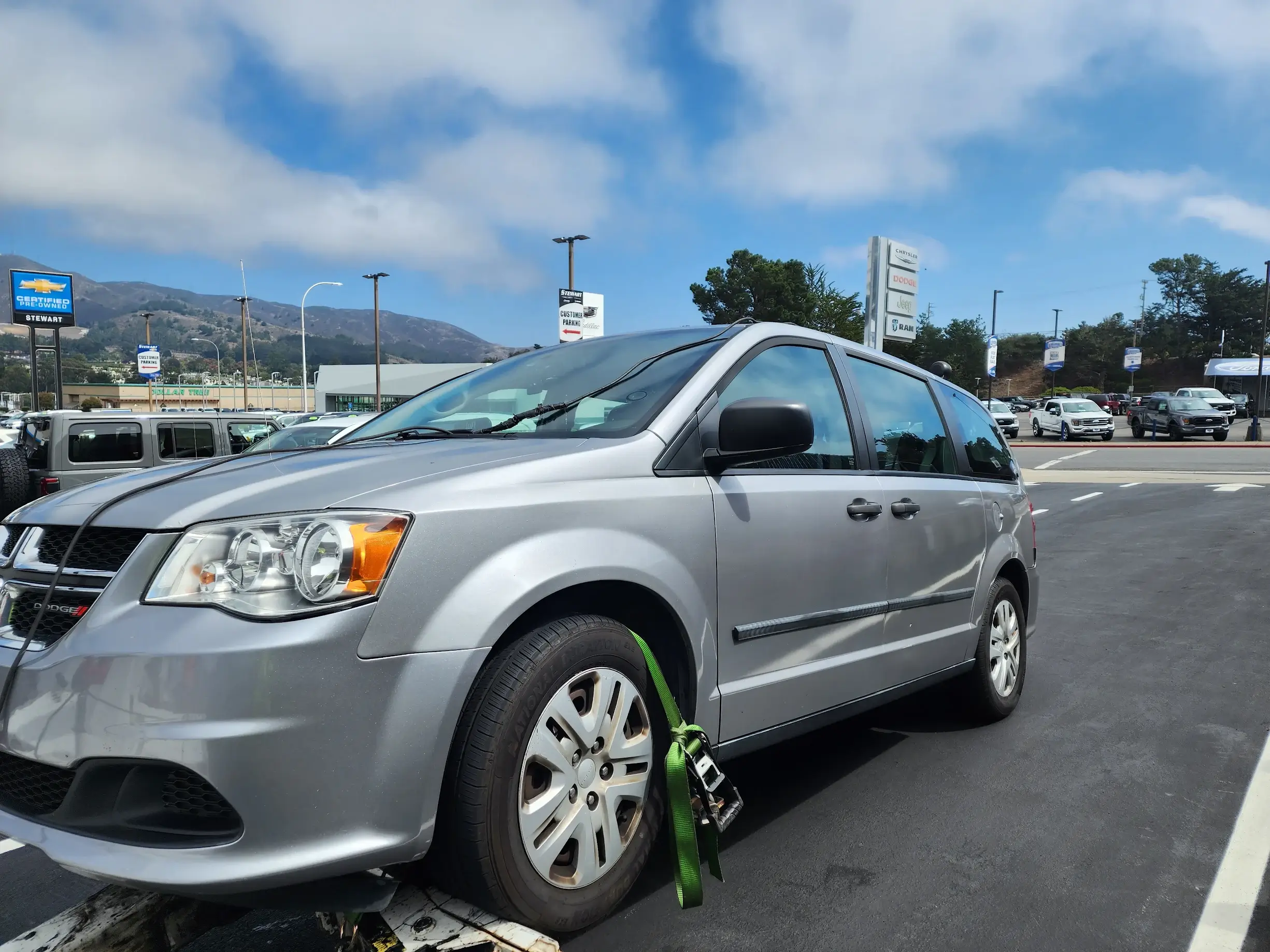 A silver van is parked in the lot