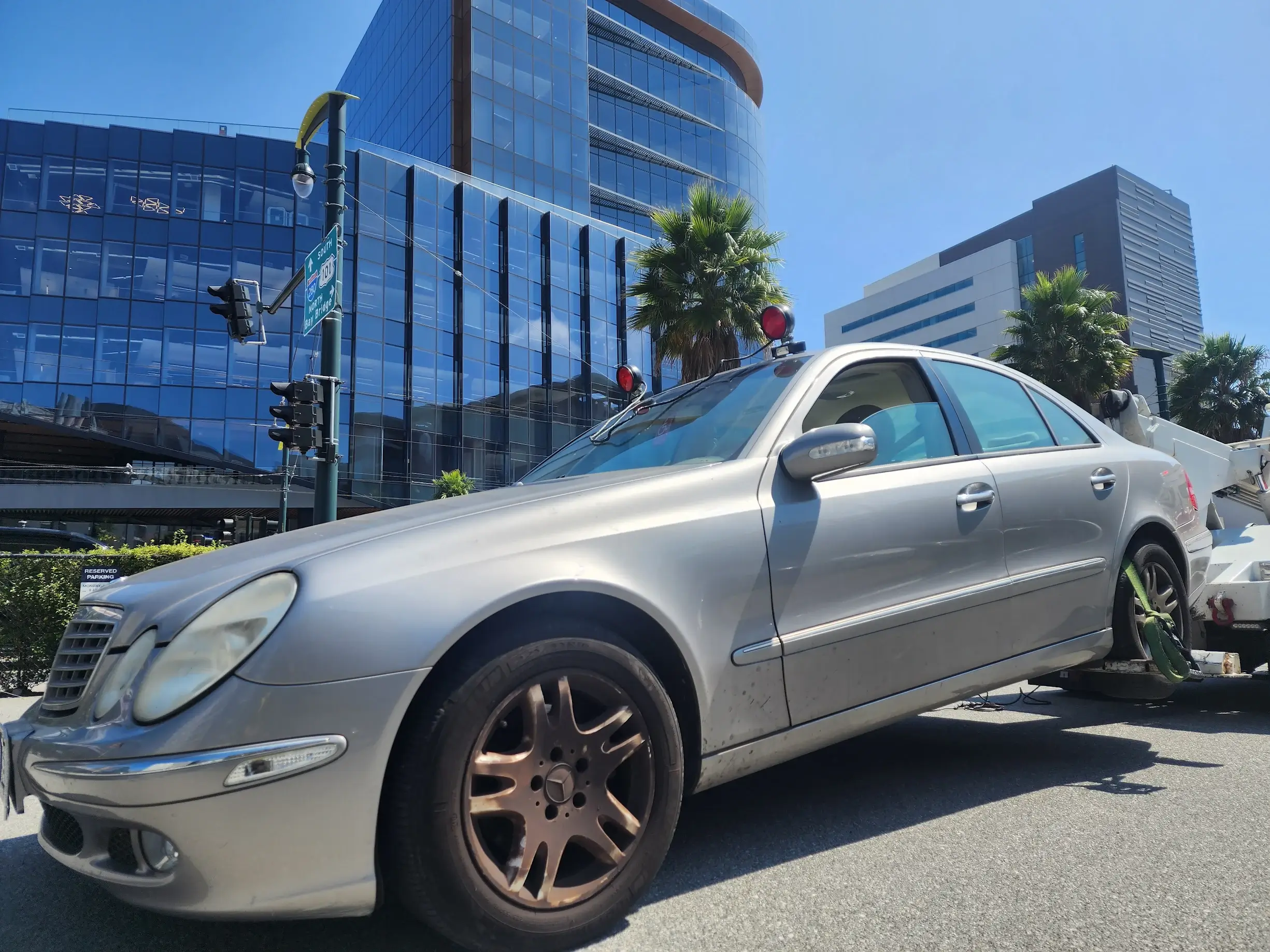 A silver car parked on the side of a road.