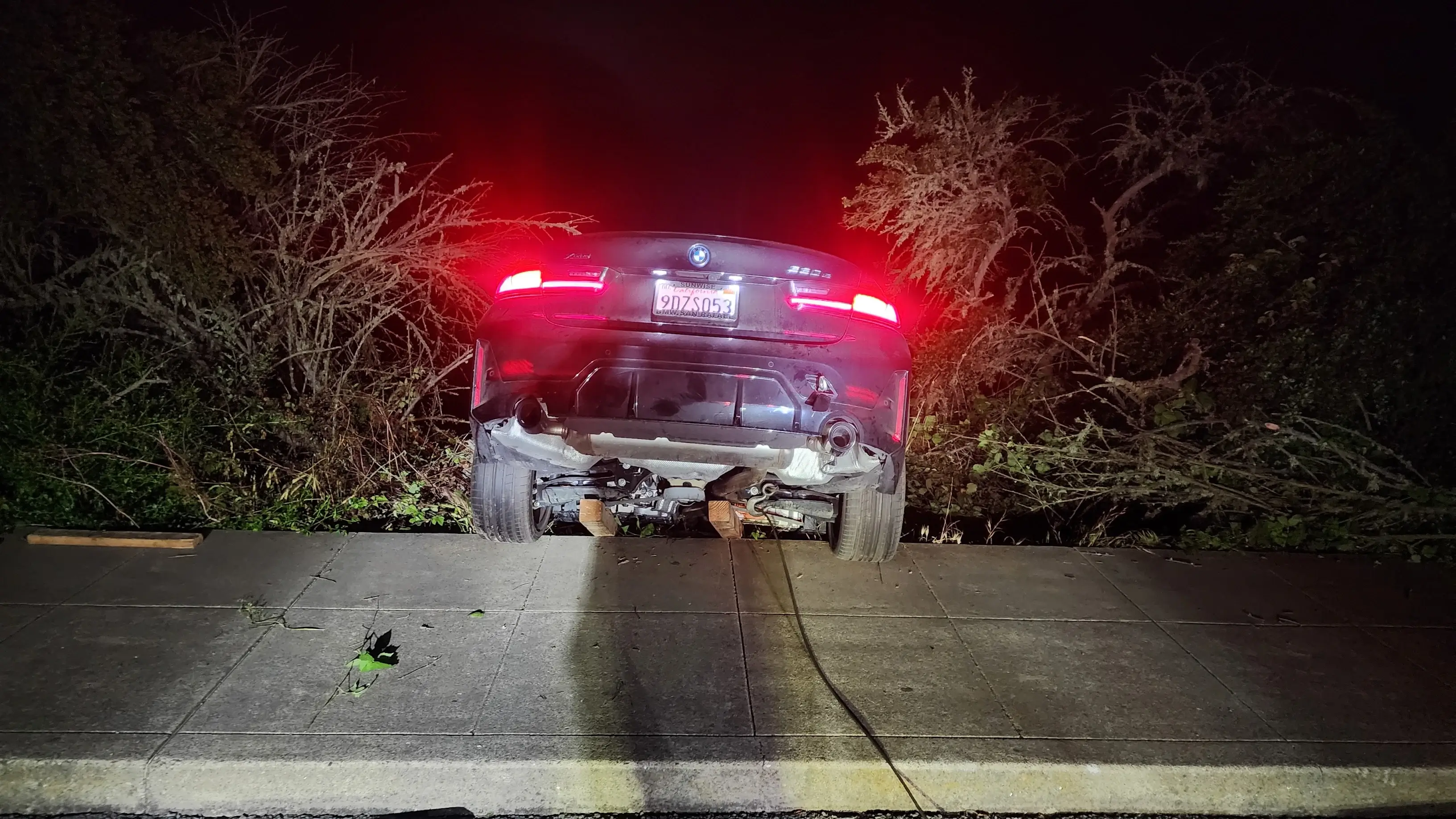 A car that has been knocked over by the road.