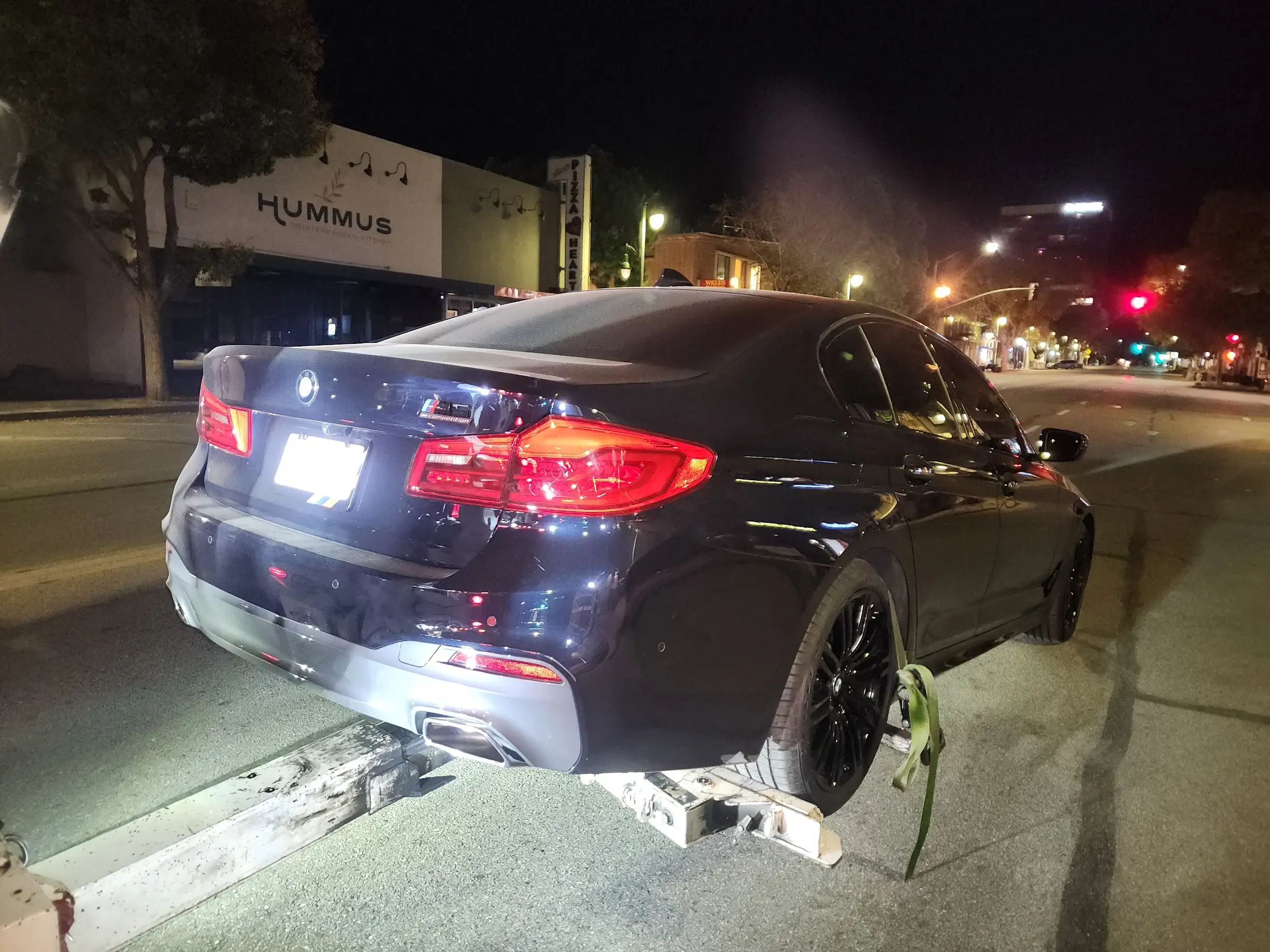 A black car is parked on the street