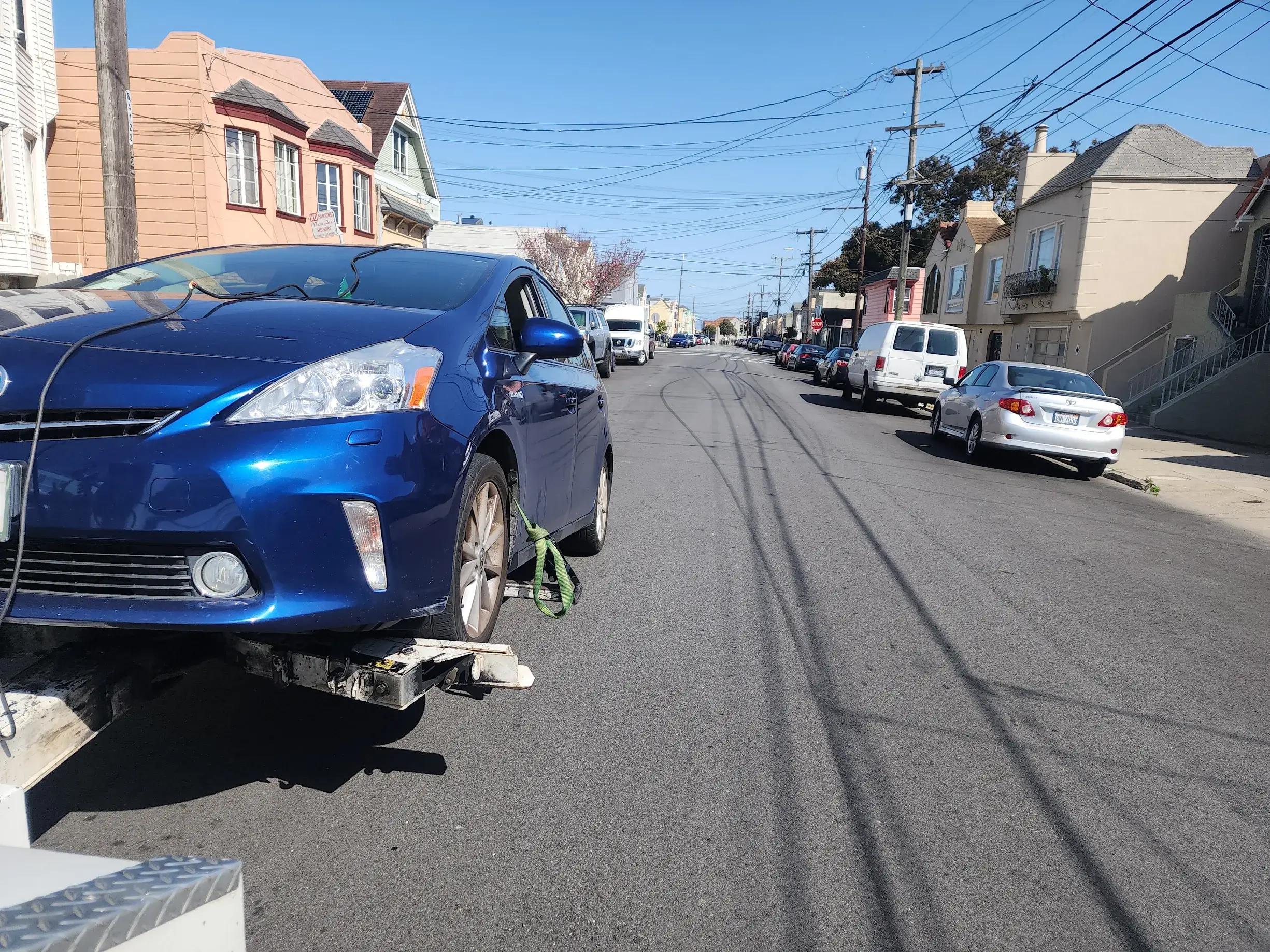A car that has been knocked over on the side of the road.