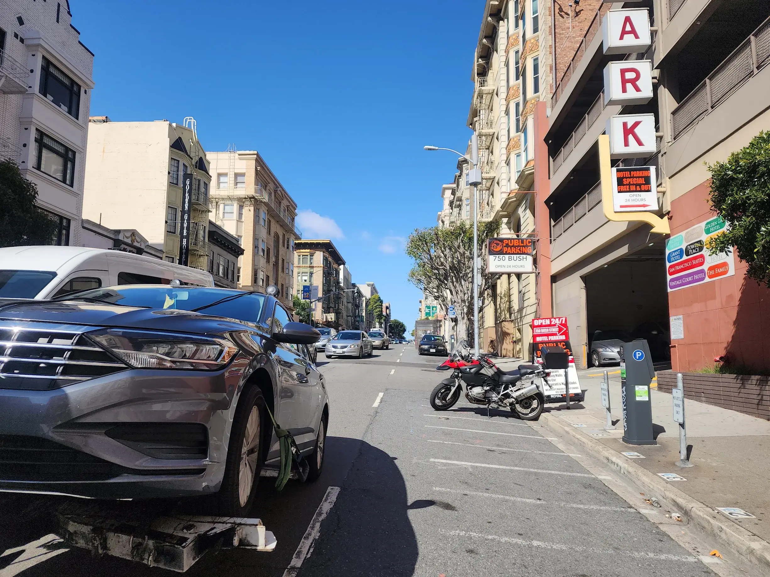 A street with cars parked on the side of it.