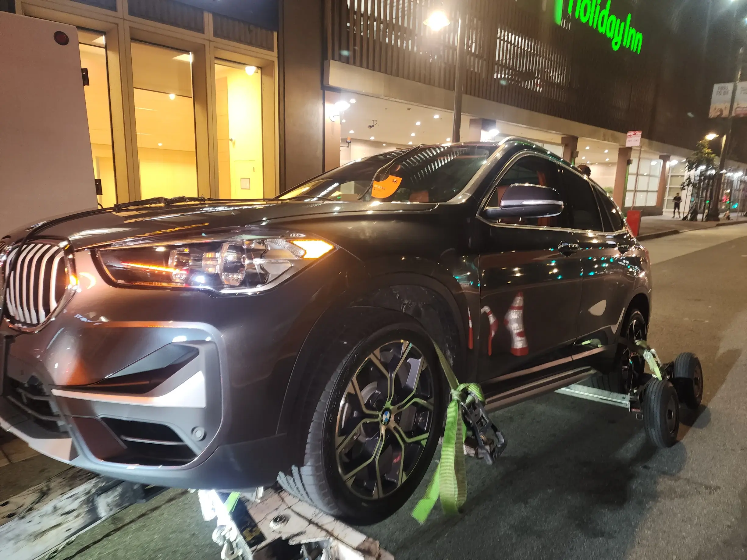 A car is being worked on by a mechanic.