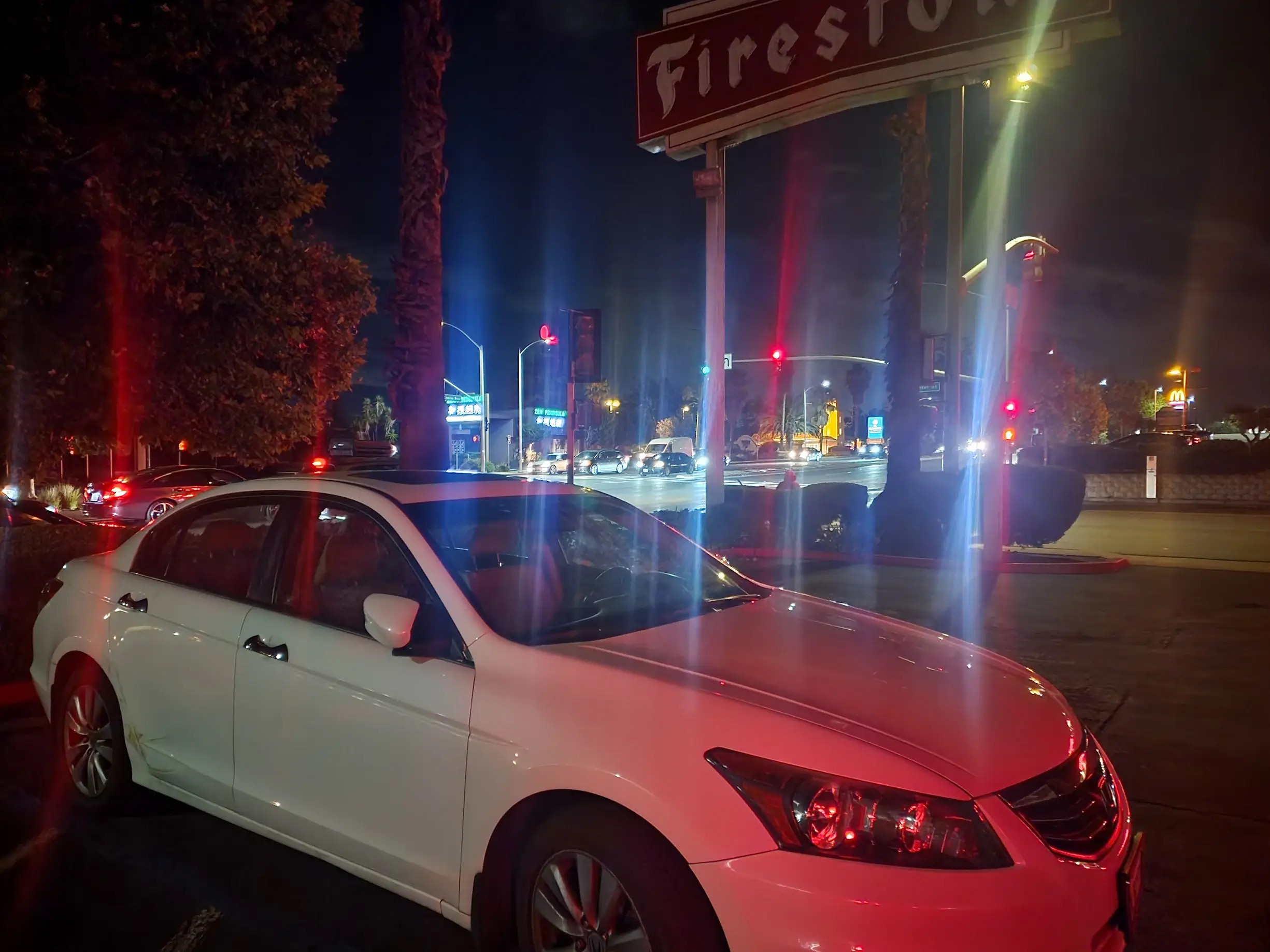 A white car parked on the side of a road.