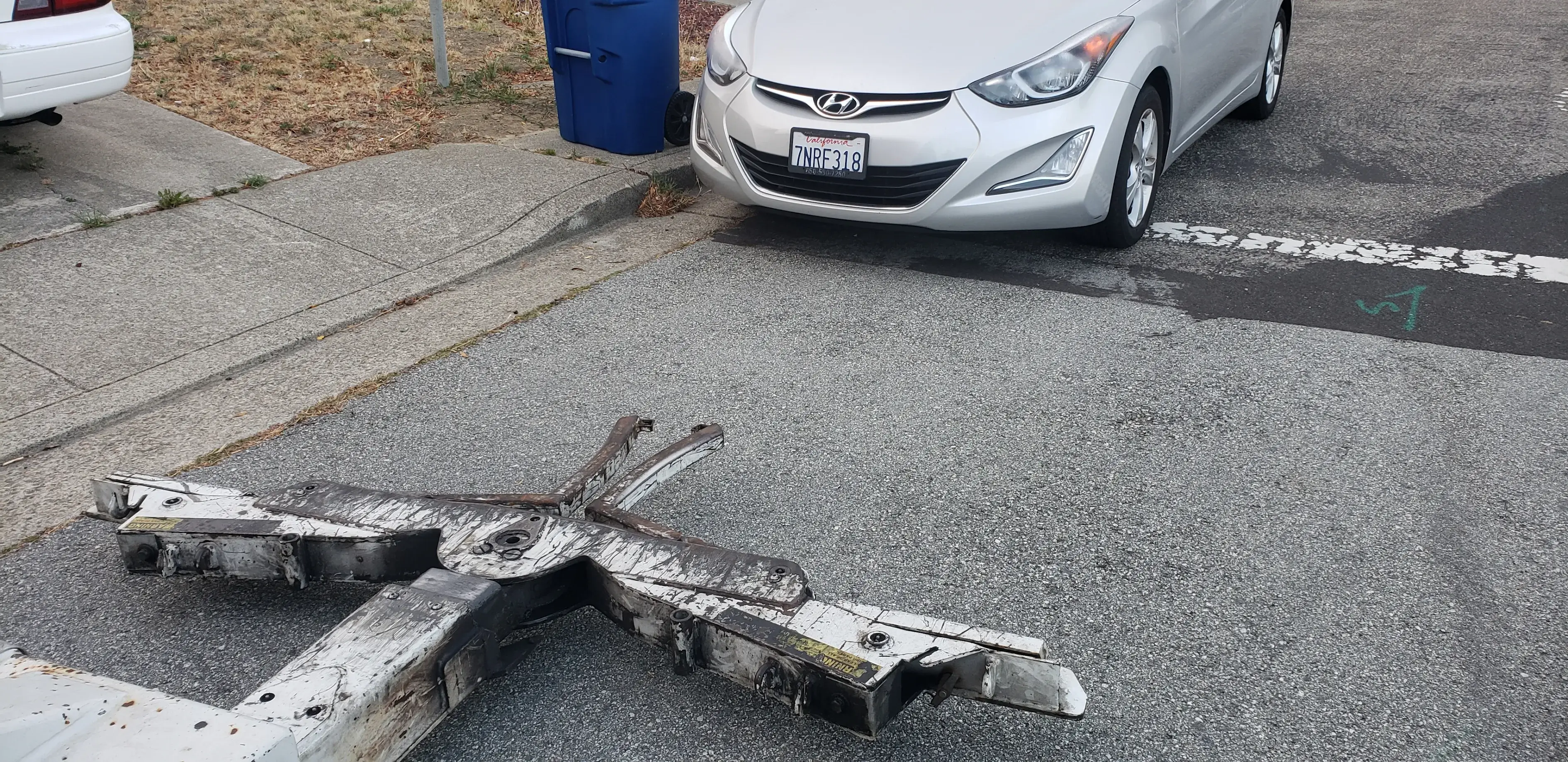 A broken down car on the side of the road.