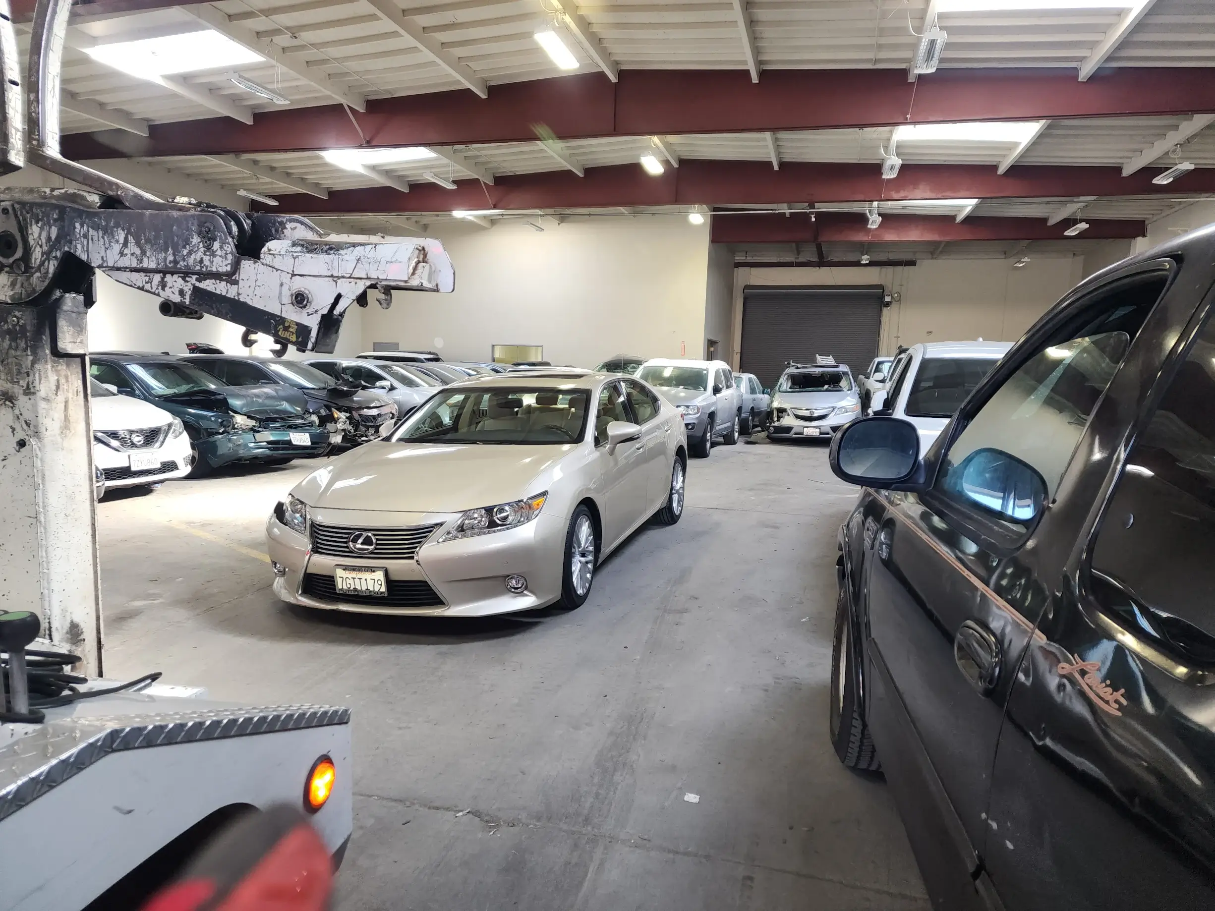 A group of cars parked in a garage.